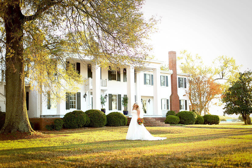bride in front of manor house