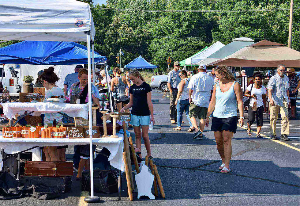 people walking at an outdoor market