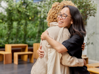two women hugging and smiling