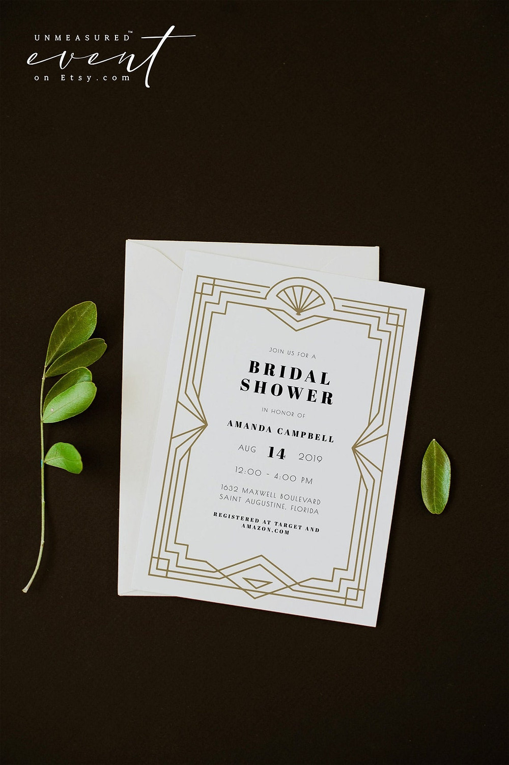 Photo of The DAISY Collection Bridal Shower Invite from Unmeasured Events that features a gold Art Deco frame and minimalist font for a 1920's glam vibe. Leaves are seen in the background. All via Unmeasured Events
