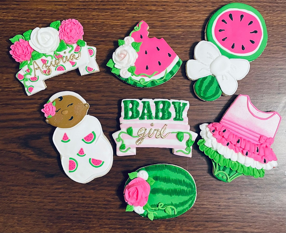 watermelon themed cookies all in various shades of pinks and greens all on a wooden table. All Via Unmeasured Events