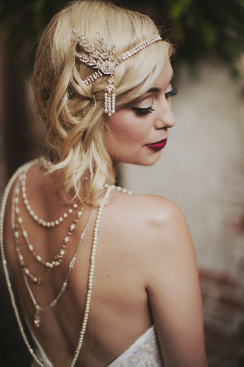 Large close up of a 1920's Flapper headband that is on the right side of her head and enlarged to show the sparkly/beaded detail. All via Unmeasured Events