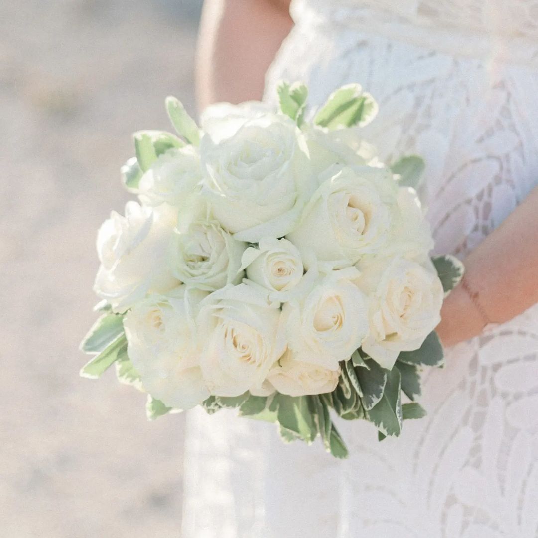 close up of an all white bridal bouquet made from roses. all via unmeasured events