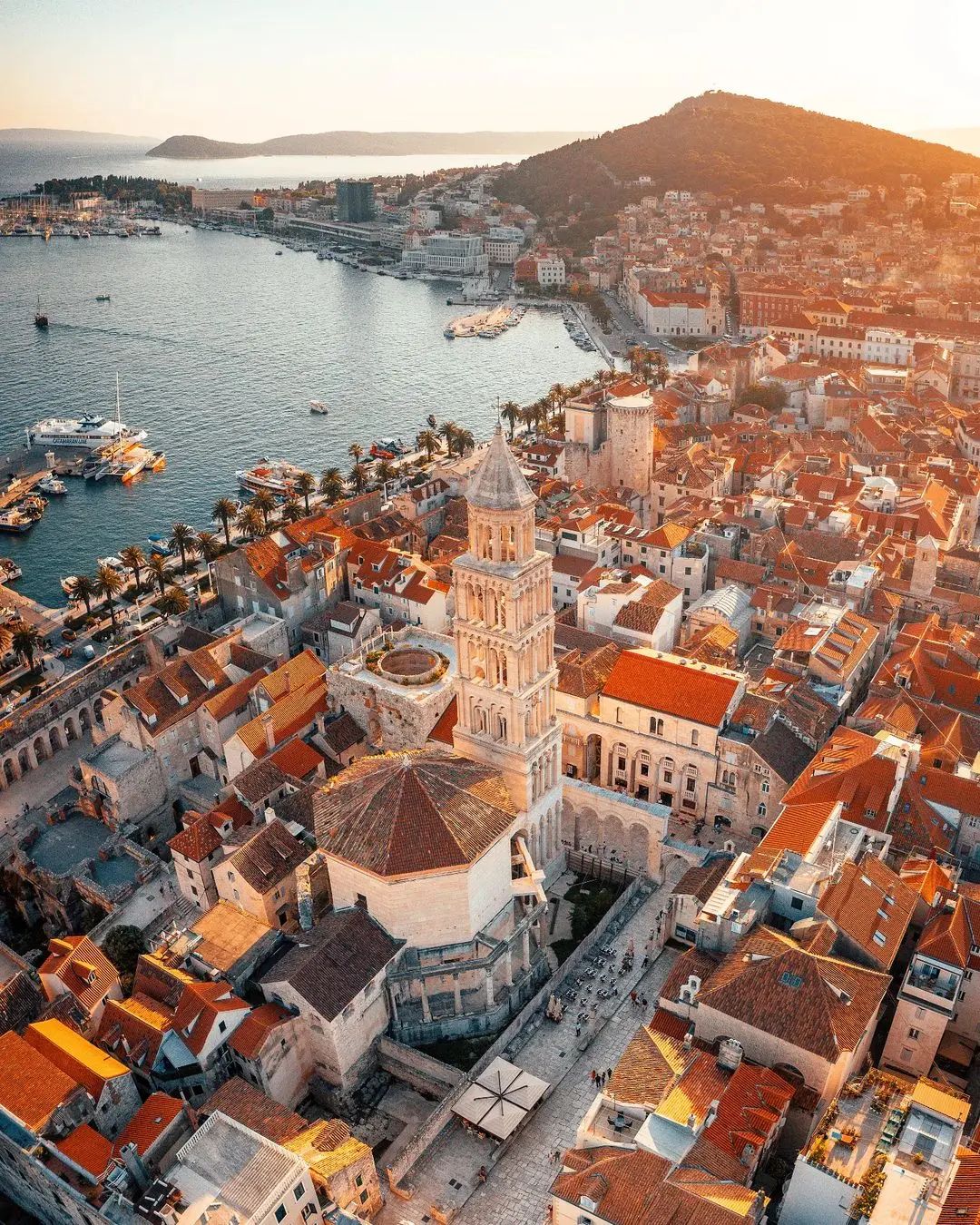 overhead view of Split, Croatia to show the colorful rooftop buildings, and the Adriatic Sea as the sun starts to wind down on this European gem. all via unmeasured events