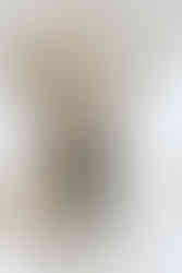 groom placing the wedding band on his new bride up at their wedding alter while guests look on. close up of their hands. all via unmeasured events