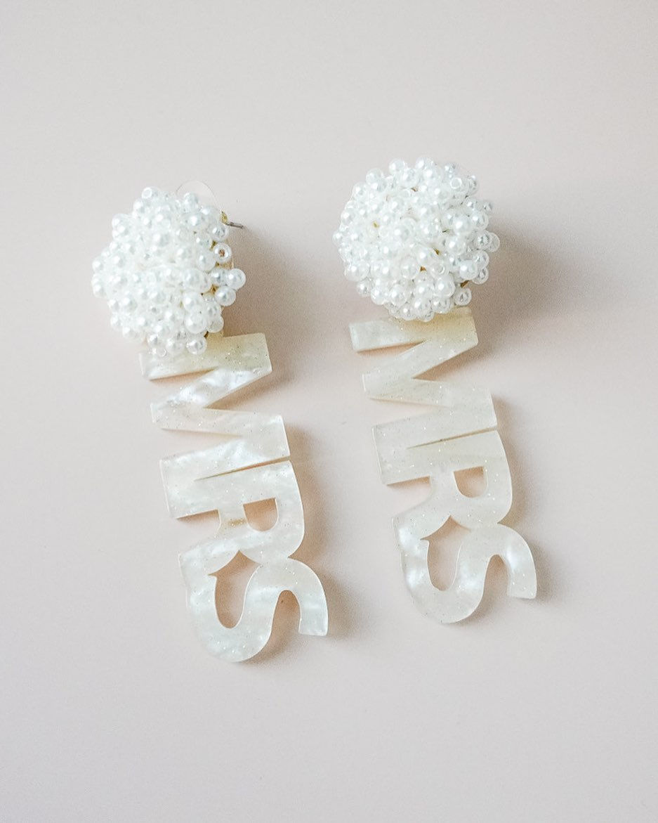 white acrylic and pearl dangle earrings that say "mrs." on a white background. all via unmeasured events