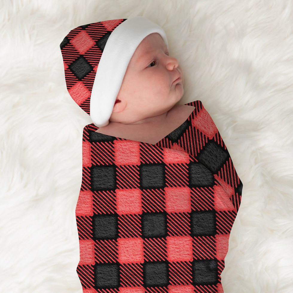 Photo of a baby wearing the FROST Collection beanie and blanket from Unmeasured Designs. This baby beanie hat features red watercolor flannel. The 100% polyester build is designed with comfort and printability in mind. Sized for infants up to roughly 6 months old, the custom baby beanie can be printed on both sides: front and back. all via unmeasured events