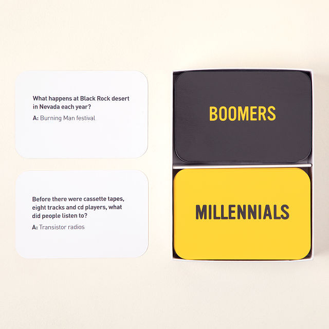 Photo of "boomers vs. millennials" card game. four cards are shown top left is white with writing and top right is a black card that says "boomers"; Bottom left of photo is a white card with writing and bottom right is a yellow card that says "millennials"