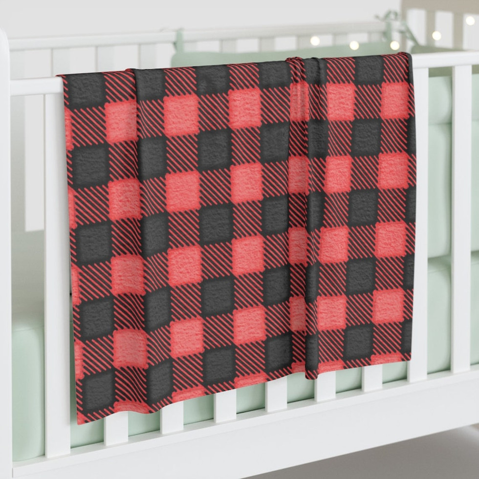 FROST Collection swaddle blanket hanging over a white crib. This swaddle blanket features red watercolor flannel. When it comes to young humans, comfort is the top priority. As such, the 100% jersey polyester that makes up the custom baby swaddle blanket is incredibly soft to the touch. all via unmeasured events