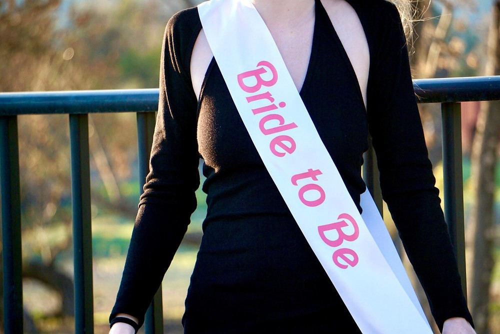 woman wearing a white "bride to be" sash in hot pink letters that match the barbie style. All via Unmeasured Events