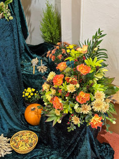 To the sides of the front display are more floral arrangements in the reds, oranges, yellows and whites which remind us of Autumn and the harvest.