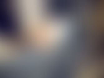 A person’s hand rests on another person’s lap.