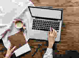 person touching keyboard of laptop
