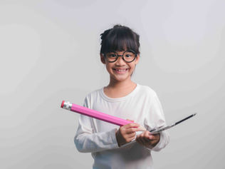 an excited young student ready to study for her PSLE