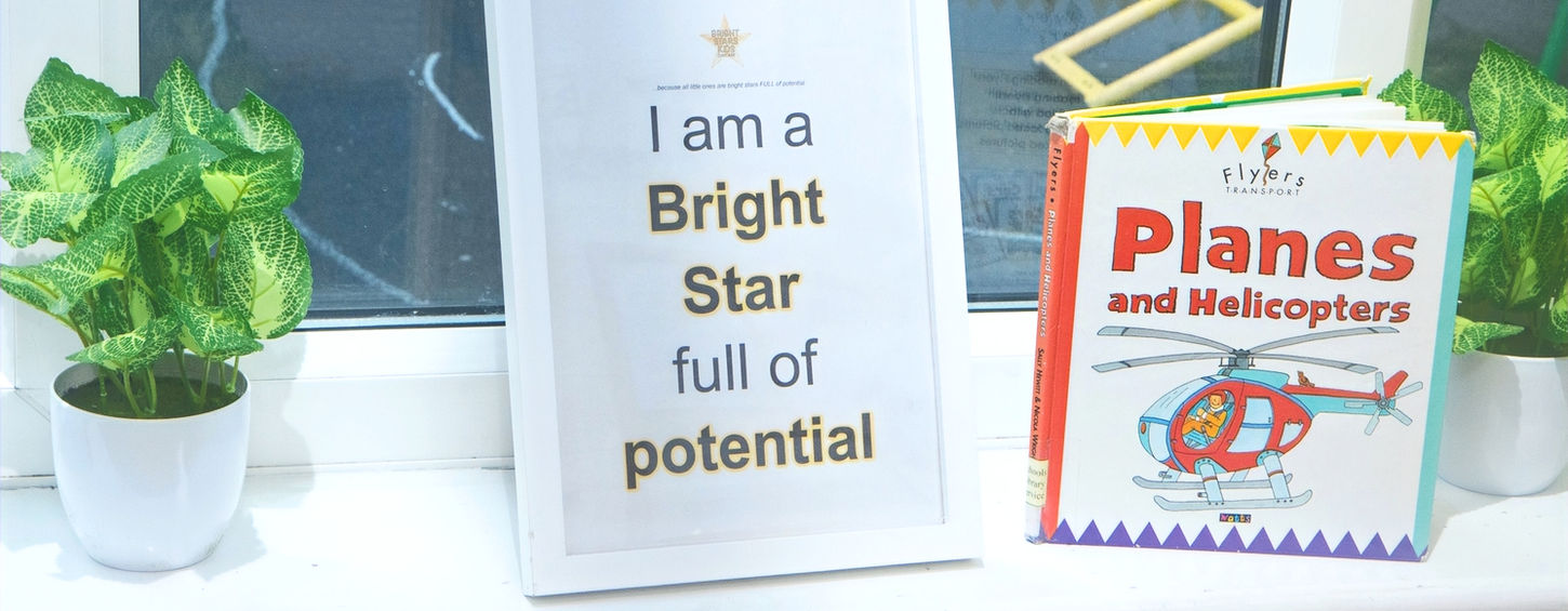 Sign says 'I am a Bright Star full of potential' next to book.