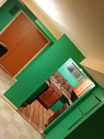 After interior painting — modern basement kitchen with green accents, clean lines, and new flooring.