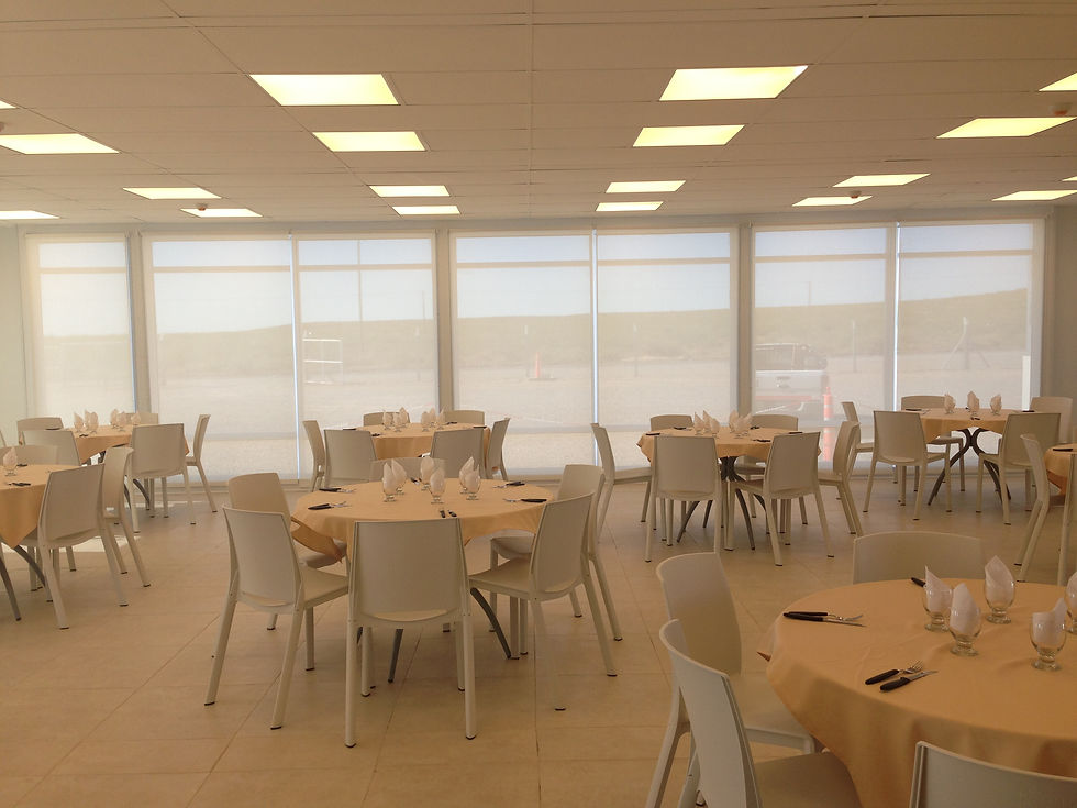 Dining hall interior with full-height glazing. Reinforces the thesis: modularity does not have to be the enemy of architectural quality.