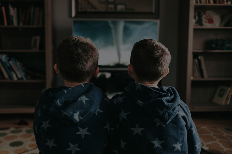 Family watching TV on a wall mounted TV