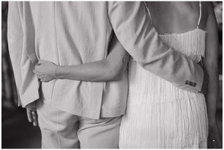 Bride and Groom lock arms for wedding portrait