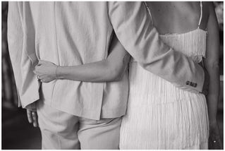 Bride and Groom lock arms for wedding portrait