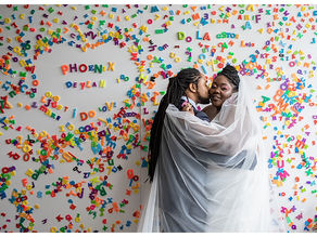 bride and groom wedding photos with letter wall art