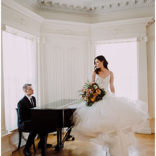 bride and groom in mansion wedding with piano