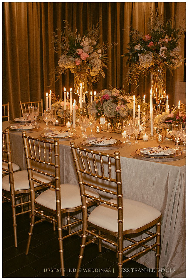 table setting at The Show Shea's Seneca with candles and dramatic tonal florals