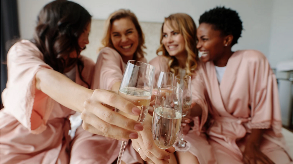girls in robes at bachelorette party with champagne