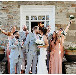bride and groom with wedding party posing for photos
