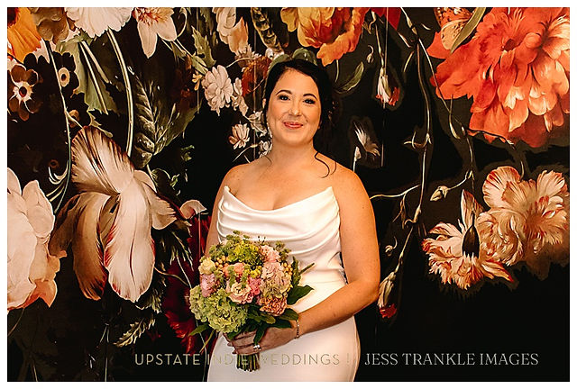 Bride with Bouquet in front of dramatic floral wall