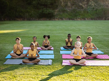 group-diverse-students-practicing-yoga-meditating-sitting-yoga-mat-garden-school_13339-302