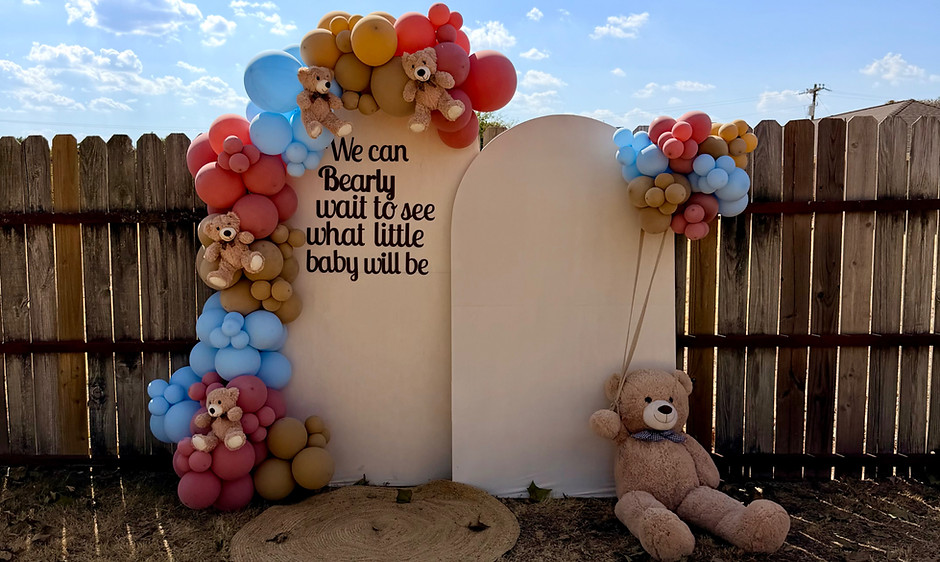 Luxury gender reveal balloon backdrop with custom signage, teddy bear theme, pastel balloon garlands, and modern arch panels 