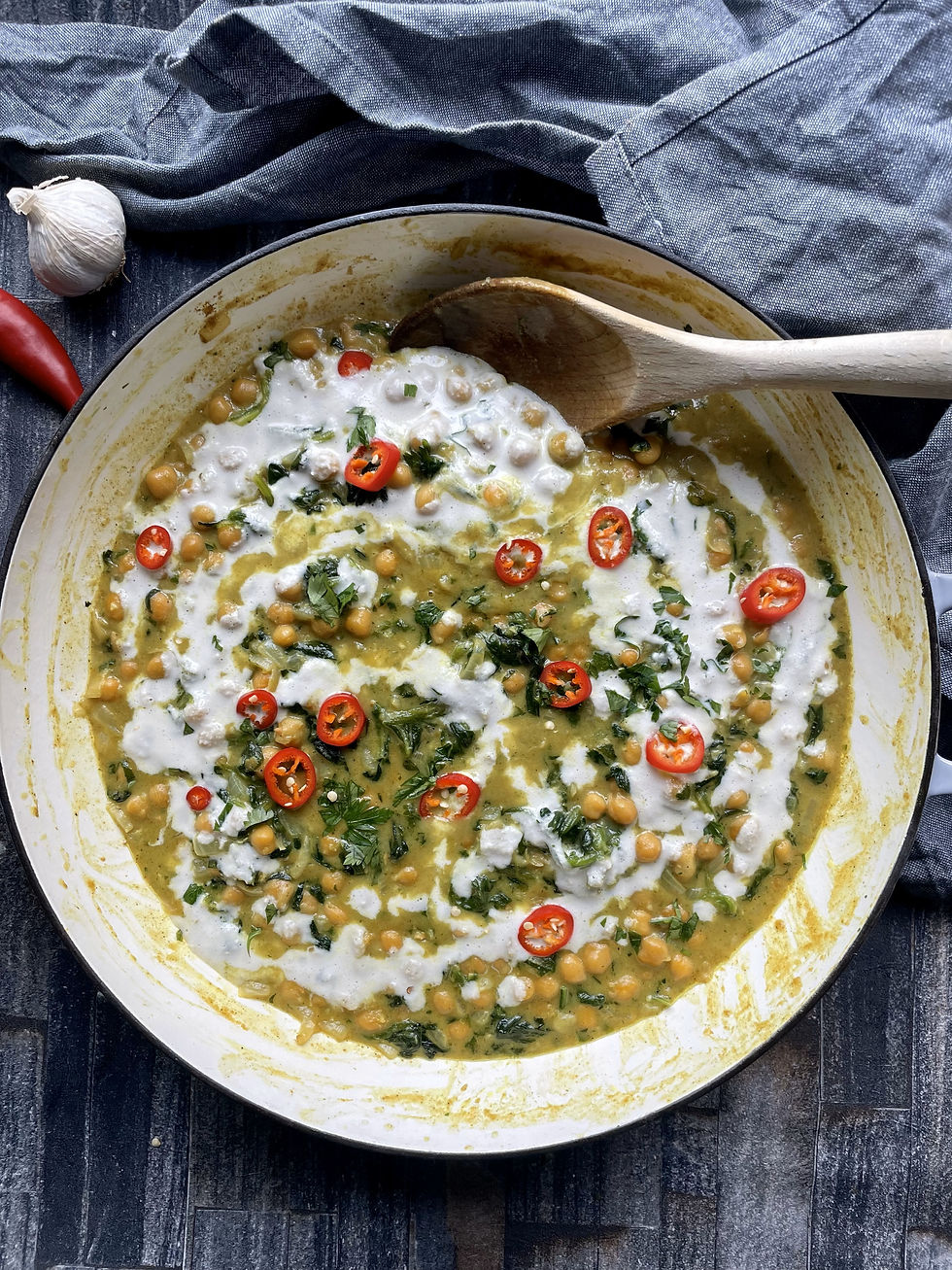 Creamy coconut curry with chickpeas, spinach and topped with red chillis