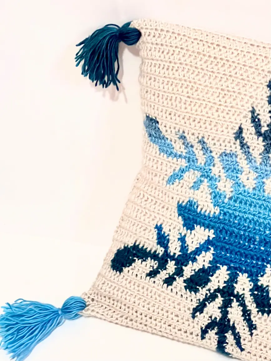 Half of the Northern Flakes Pillow Case, crocheted with blue gradient colour and tassels.