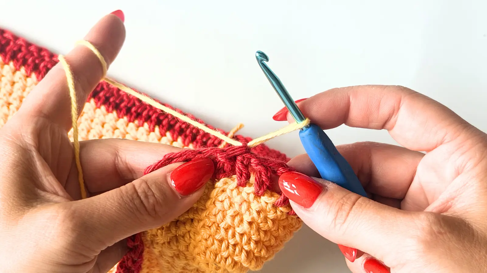 Beginning the next round with Colour C (Yellow Multi) and working the first stitch.
