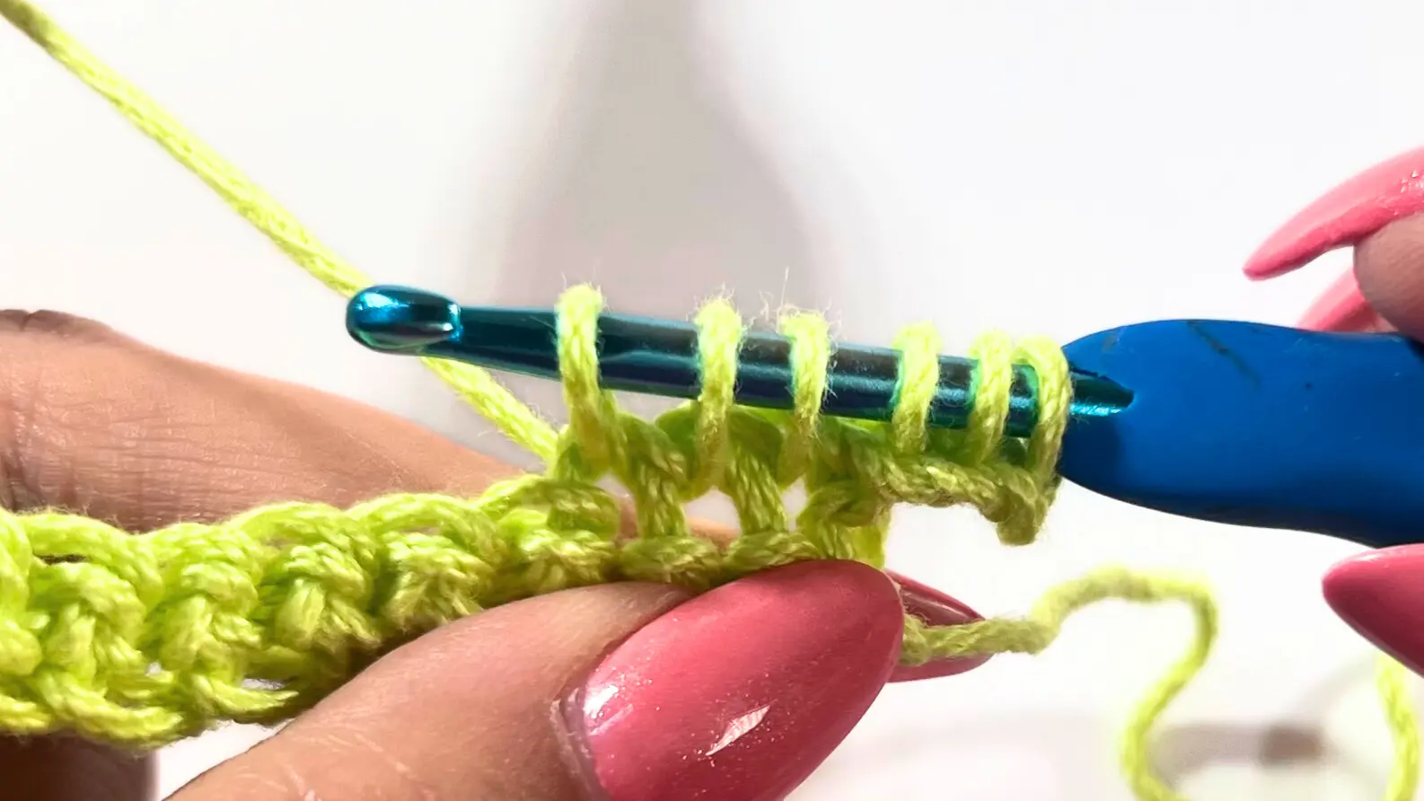 All six loops gathered on the hook, just before yarning over to pull through all loops.