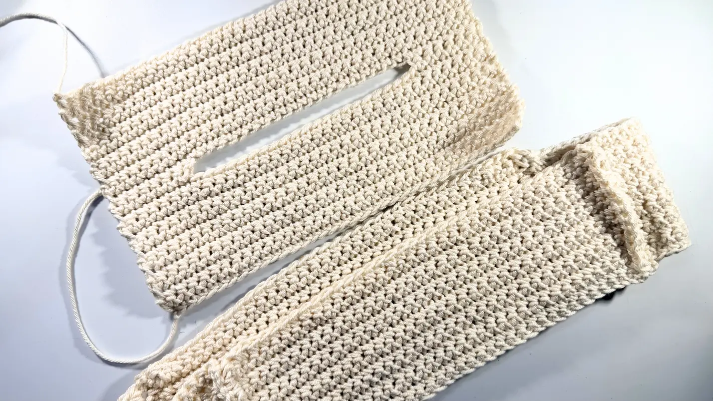 Crochet tissue box cover pieces showing the top panel with an opening and the assembled side section before final seaming.