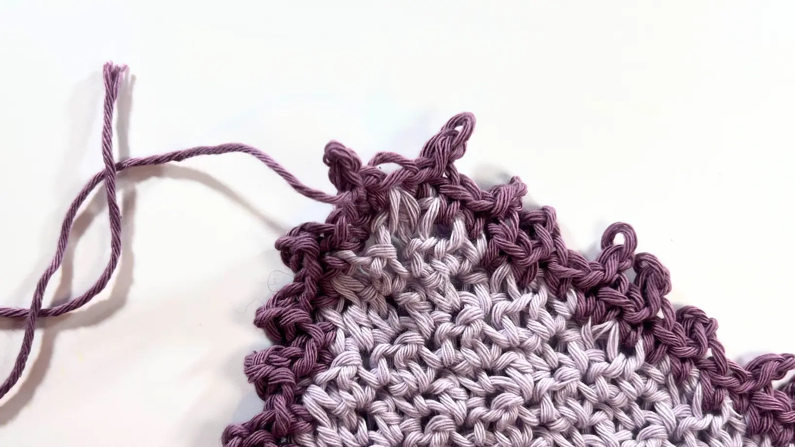 Finished lavender washcloth with a full round of darker purple Picot Border, adding a delicate scalloped edge.