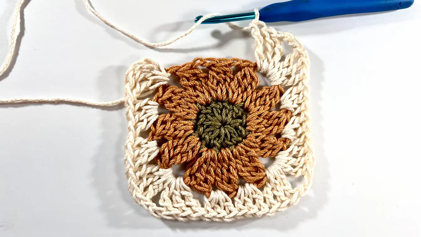 Finished Daisy Granny Square with all four corners worked, forming a complete square.
