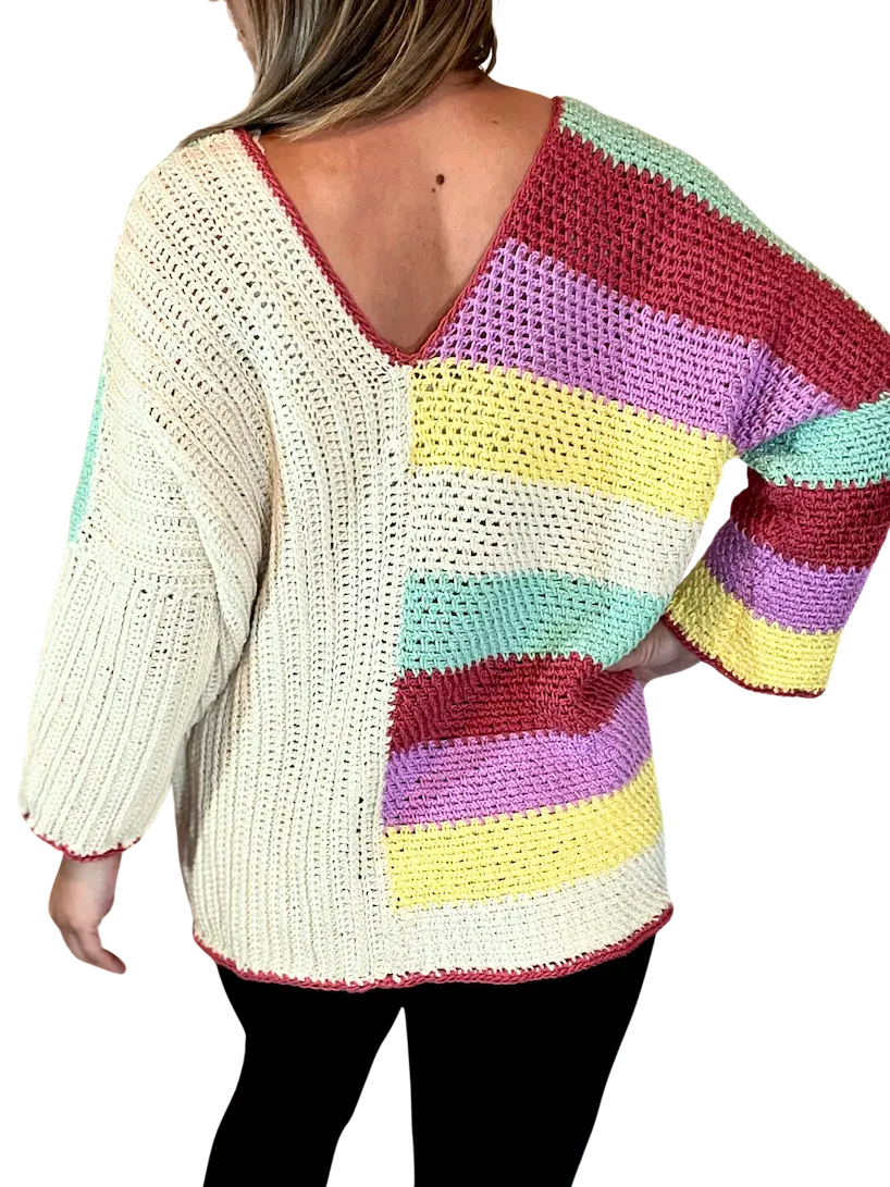 Back view of the Happy Stripes Sweater crochet pattern, featuring one half in cream vertical stitches and the other in colourful horizontal stripes, finished with a V-neck and relaxed fit.