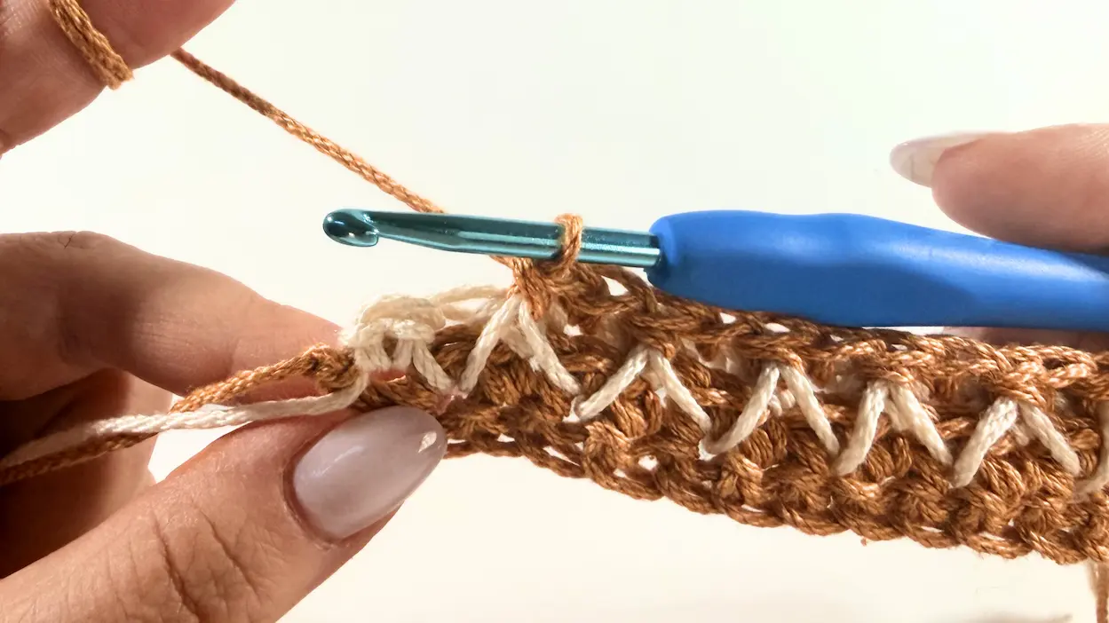 Working the last stitches of Row 4.