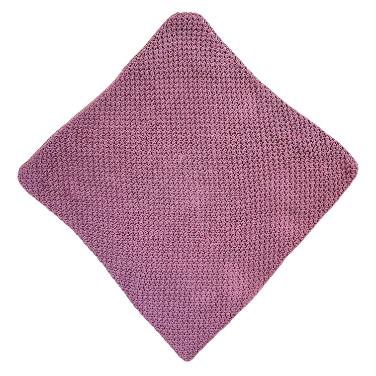 Finished square crochet panel in dusty lavender yarn made with C2C Even Moss Stitch. The square is laid flat with neat, consistent stitch texture and rounded corners, ready for the next step in the hooded baby towel assembly.