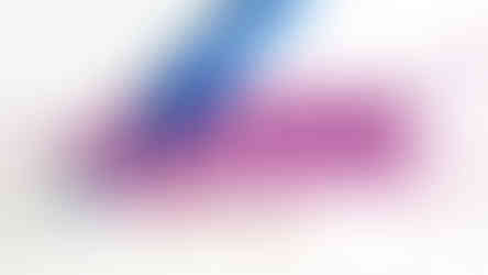 Finishing the 5th row of the Alpine Stitch around last stitch. Done in pink yarn and blue crochet hook on a white background.