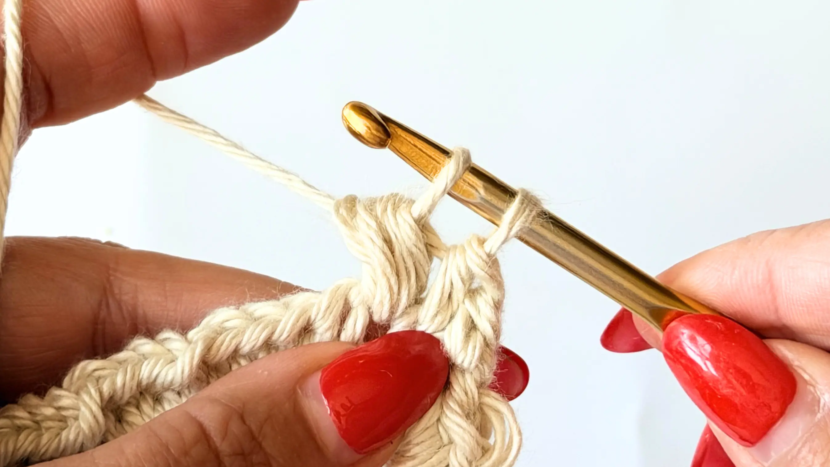 Pull the yarn through six loops, leaving two loops on the hook.
