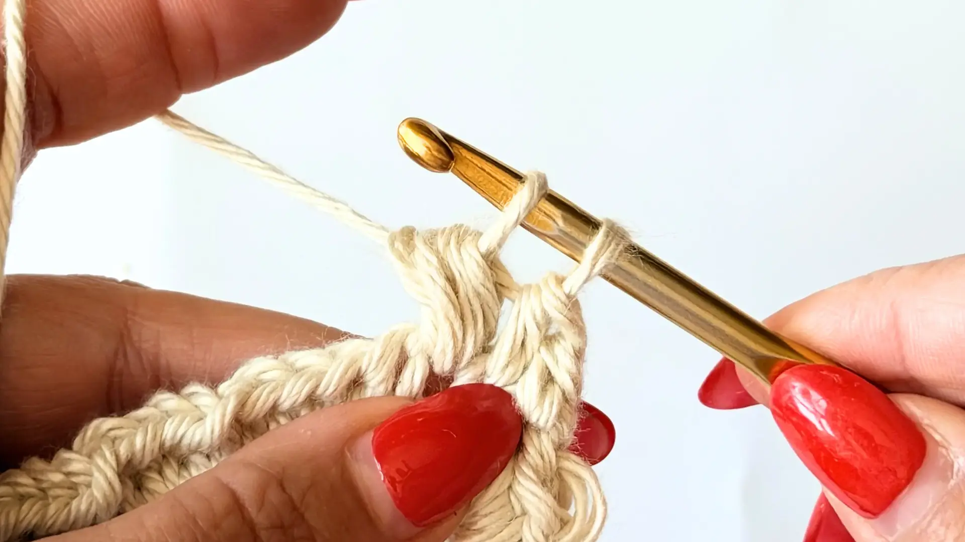 Pull the yarn through six loops, leaving two loops on the hook.
