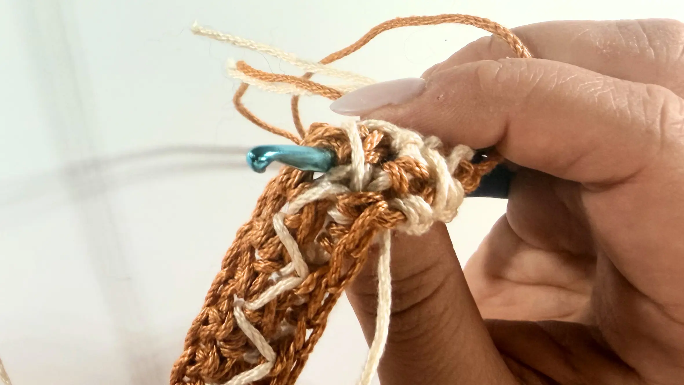 Checking that the hook is positioned directly under the peak of the connected stitches before completing the Spike Stitch.