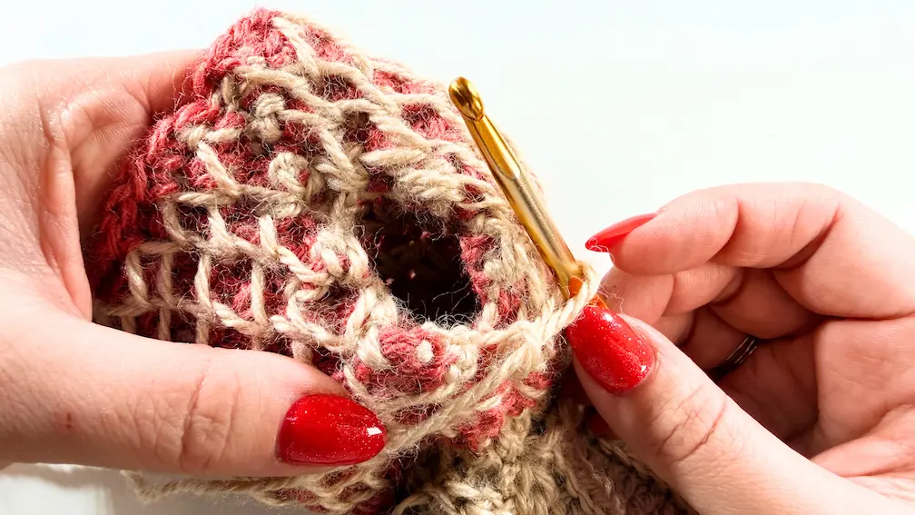 Crocheting the edging around the thumb opening on honeycomb fingerless gloves.
