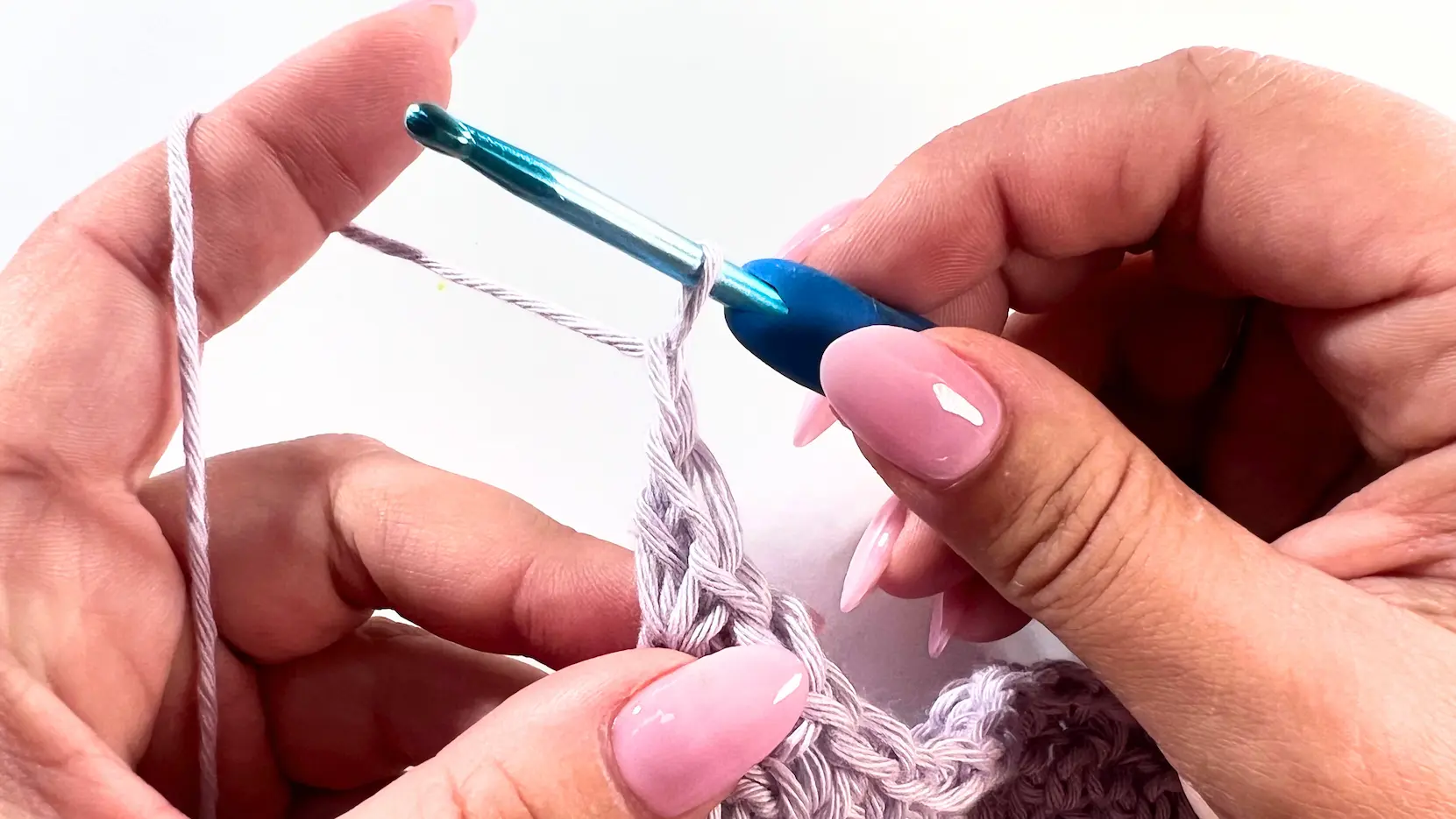 Crochet hook and light purple yarn showing turning chain for the next row in the Lemon Peel Stitch C2C baby washcloth.