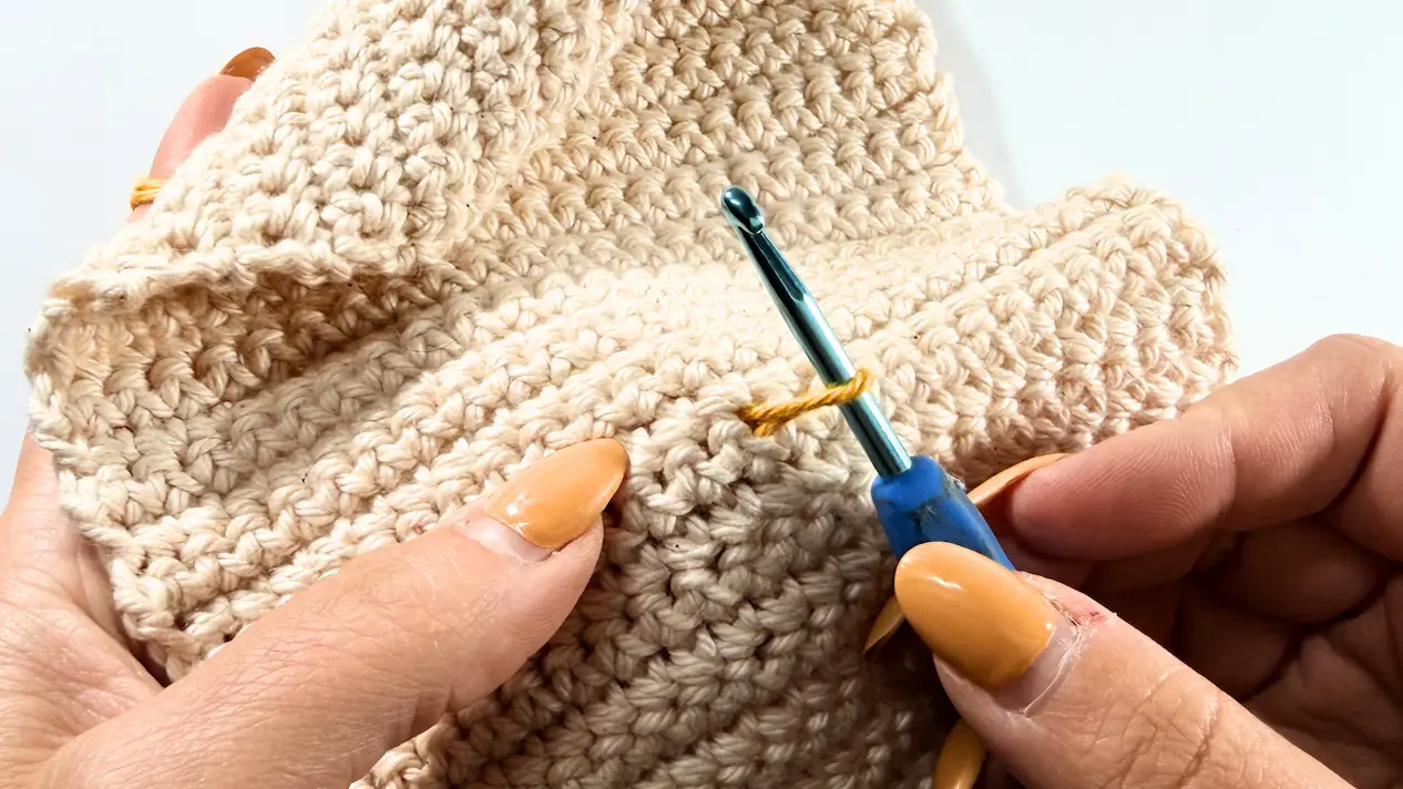 Pulling up the first loop to start working surface crochet on the Kindle sleeve.
