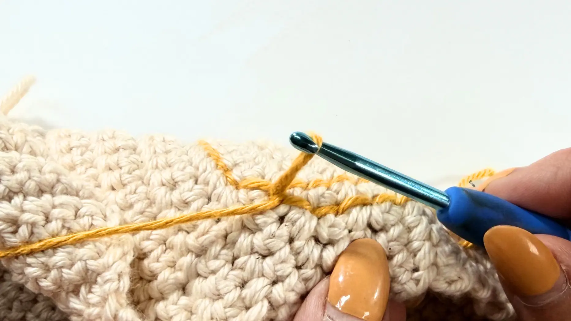 Surface crochet loop pulled to the back of the project and ready to be fastened off.